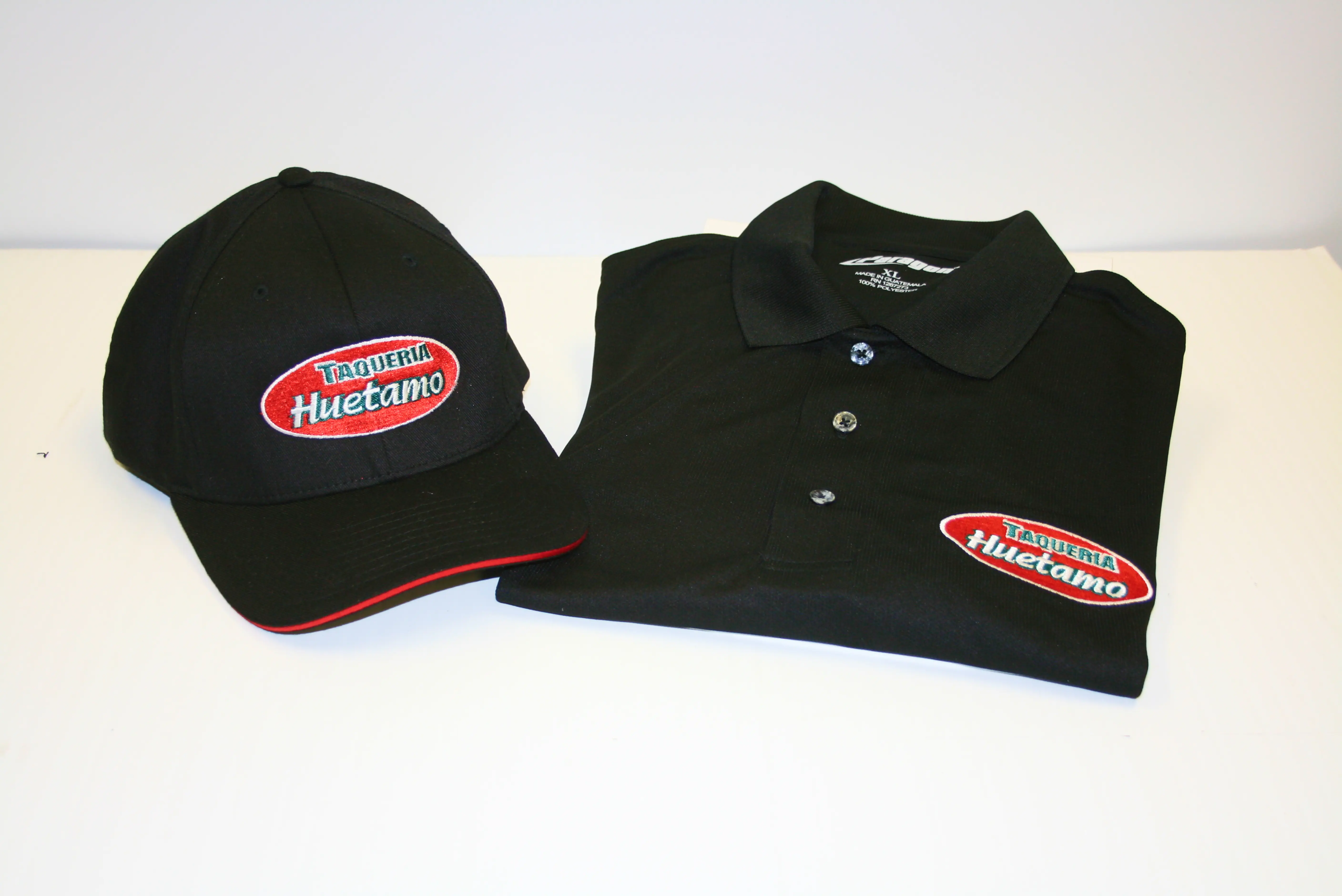 Custom branded work apparel including shirts, polos and hats